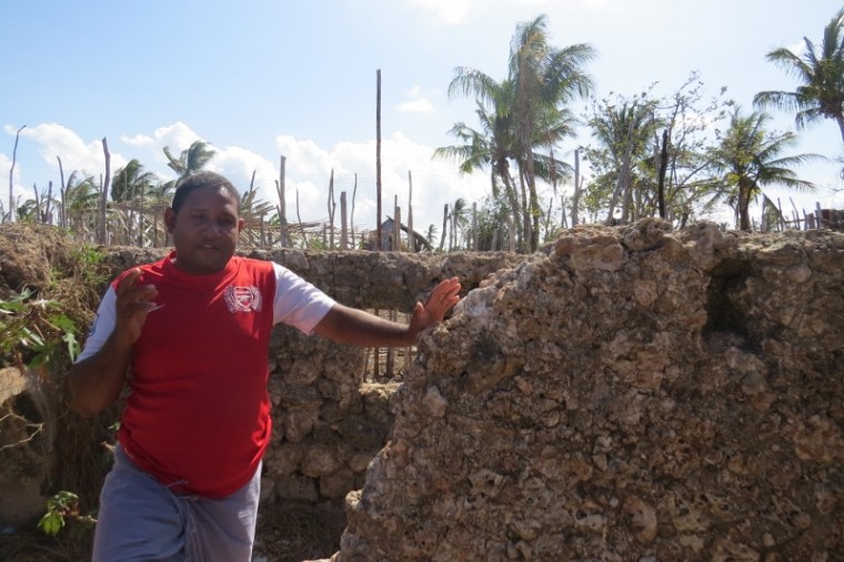 Bwanamkuu Mohamed Hamdu at the grave of the seven virgins who asked God to divine and committed suicide rather than be defiled when the Portuguese invaded the island about seven centuries agoon Pate island Copyright Maya Mangat