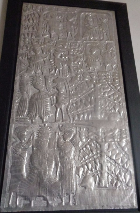 Hammered aluminum panel by the late Asiru Olatunde from Oshogbo Nigeria. Asiru was a former blacksmith who started rolling out metal panels depicting Yoruba mythology in the 1960s. His son Folorunso is carrying on this craft. This panel depicts the “Story of the Four Breasted Woman”
