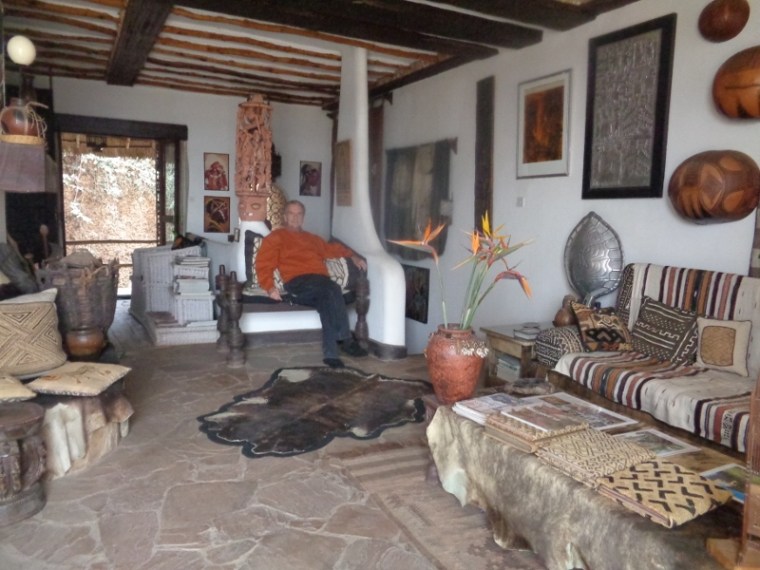 Alan Donovan seated at African Heritage House with his collection of African arts. Copyright Rupi Mangat
