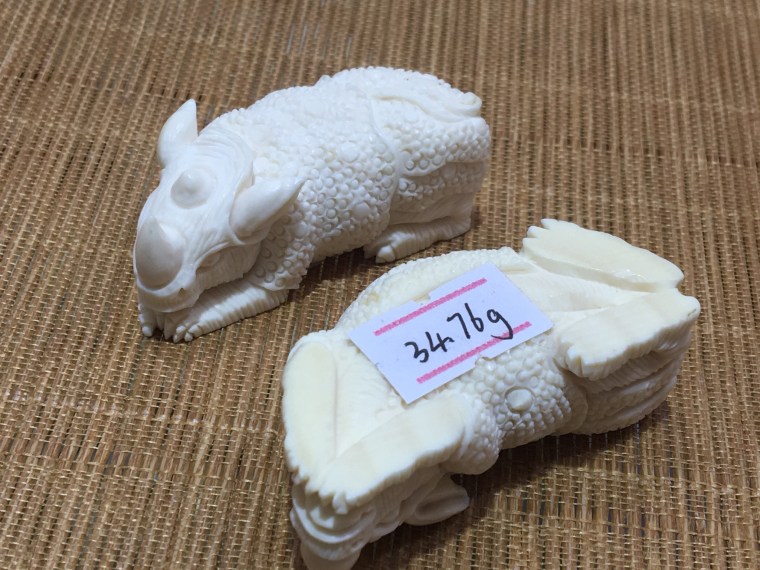 For the rhino figurines, with the weight on its base - illegal ivory items are being mass produced without artistic merit Copyright Lucy Vigne