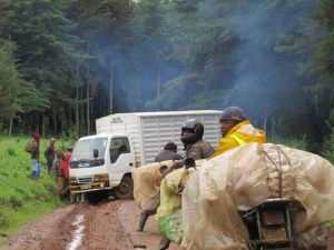 Traffic snarl up Mt Kenya -Potato sacks being transported on motor bikes waiting for lorry to be straightened out - copyright Rupi Mangat