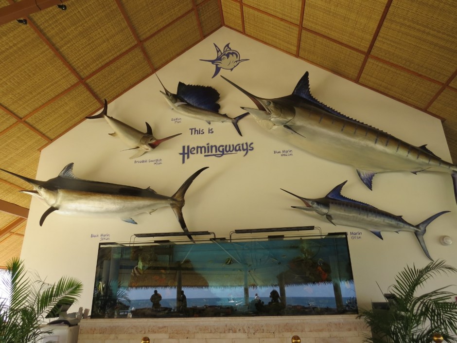 Restaurant at Hemingways with life size caste models of deep-sea fish and aquarium with coral fish. Copyright Rupi Mangat