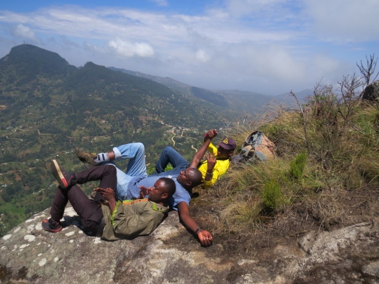 On the peak of Iyale overlooking Taita -a well deserved break from l to r- Handrison Mwameso, Maina Gichia and Evanson Jardel Wangusha, a guide with Dawida Biodiversity Conservation group (DABICO) copyright Rupi Mangat