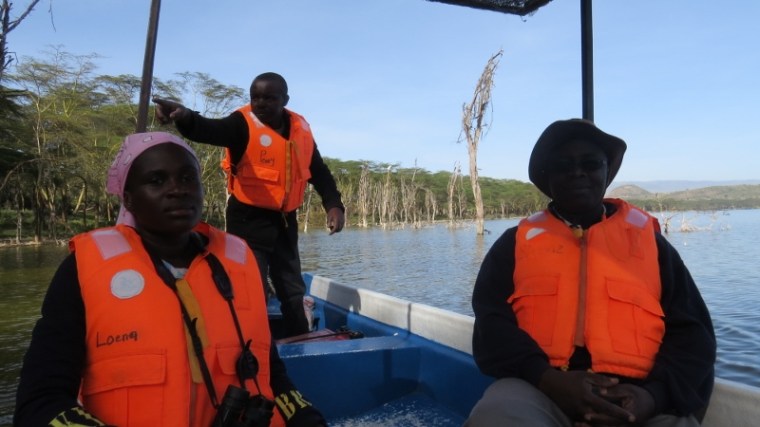 Peter Kariuki pointing to birds on Lake Oloiden. Copyright Rupi Mangat